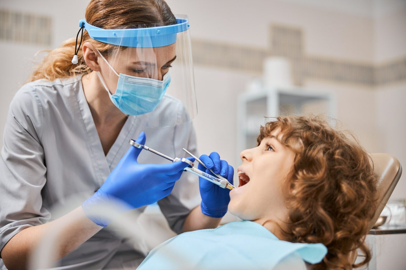 professional-dentist-is-giving-anesthesia-to-a-child-1536x1024